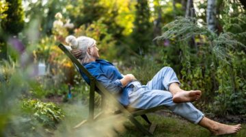 A woman relaxing in a garden.