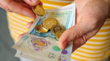 A woman holding cash in her hands.