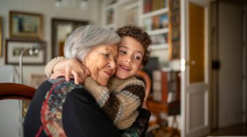 A woman hugging her grandchild.