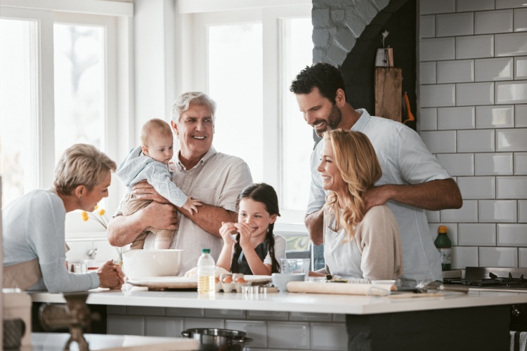 Three generations of family cooking in the kitchen