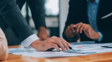 People in a business meeting reviewing paperwork.
