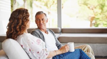 A couple talking in their home.