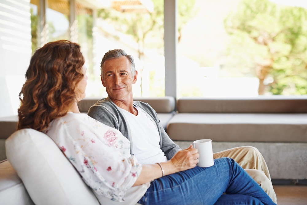A couple talking in their home.