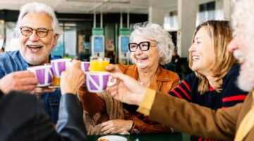 A group of people talking and drinking tea.