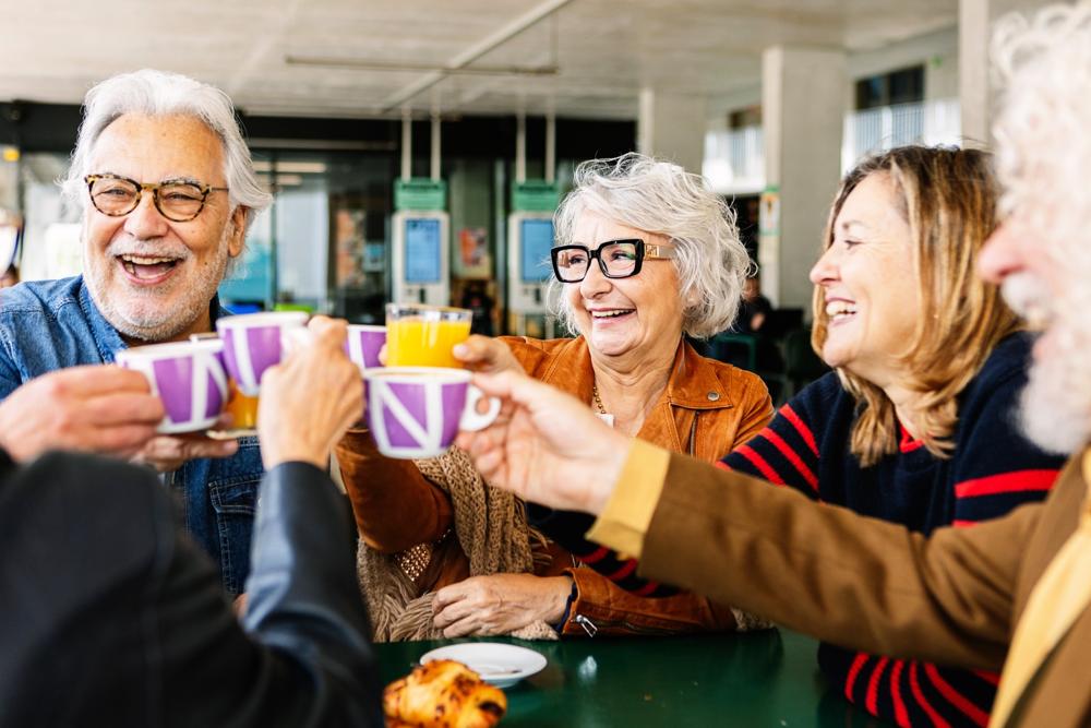 A group of people talking and drinking tea.