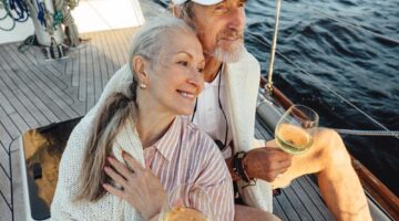 A couple sitting on a yacht deck.